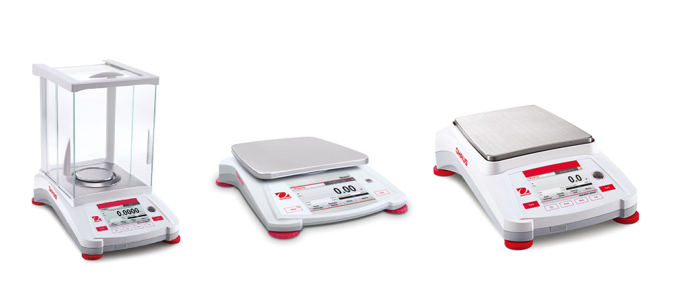 Three Ohaus laboratory balances - AX124, STX2202, and AX12001 models for precision weighing applications