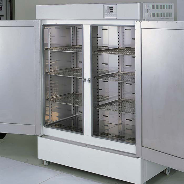 Yamato DKN-912C 535L Programmable Laboratory Oven interior view with double doors open, showing the stainless steel chamber, adjustable wire shelves, and forced air circulation design.